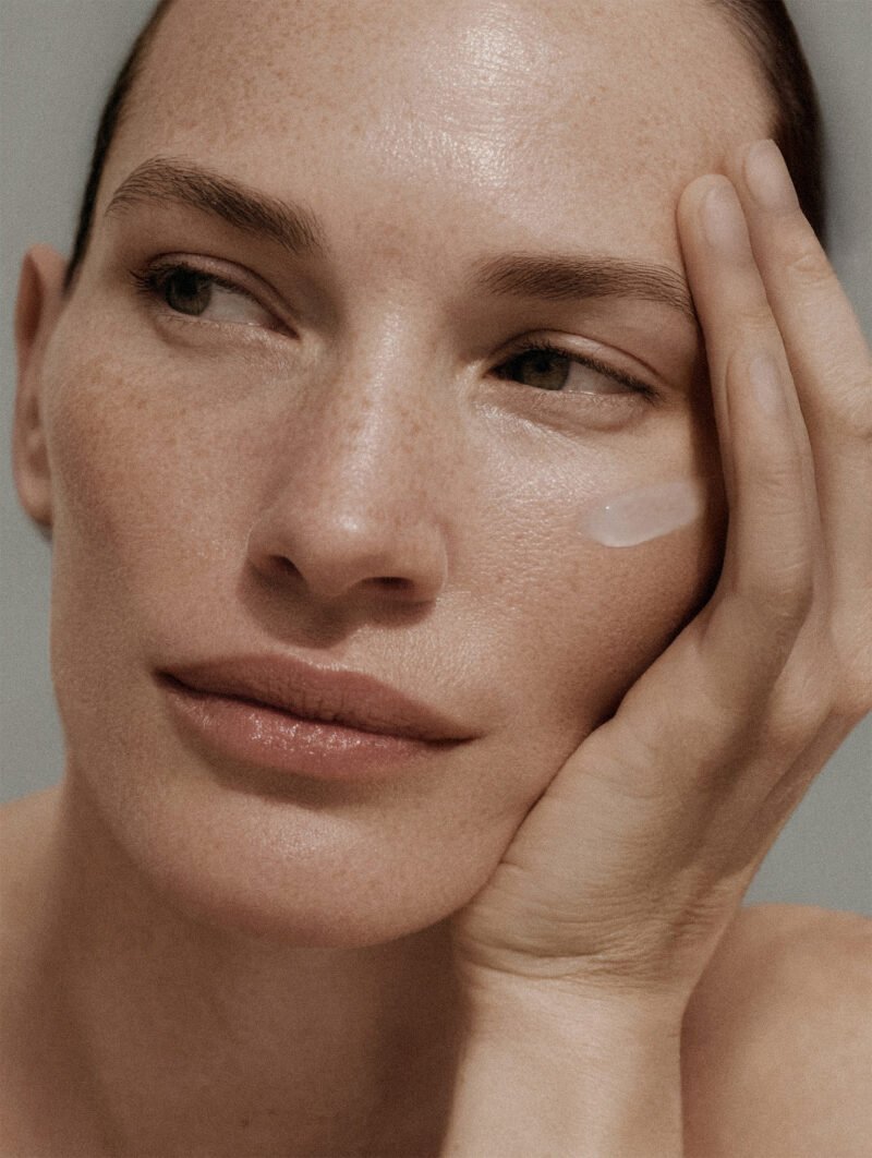 Model applying Nucleum by Naccentia – advanced luxury skincare treatment