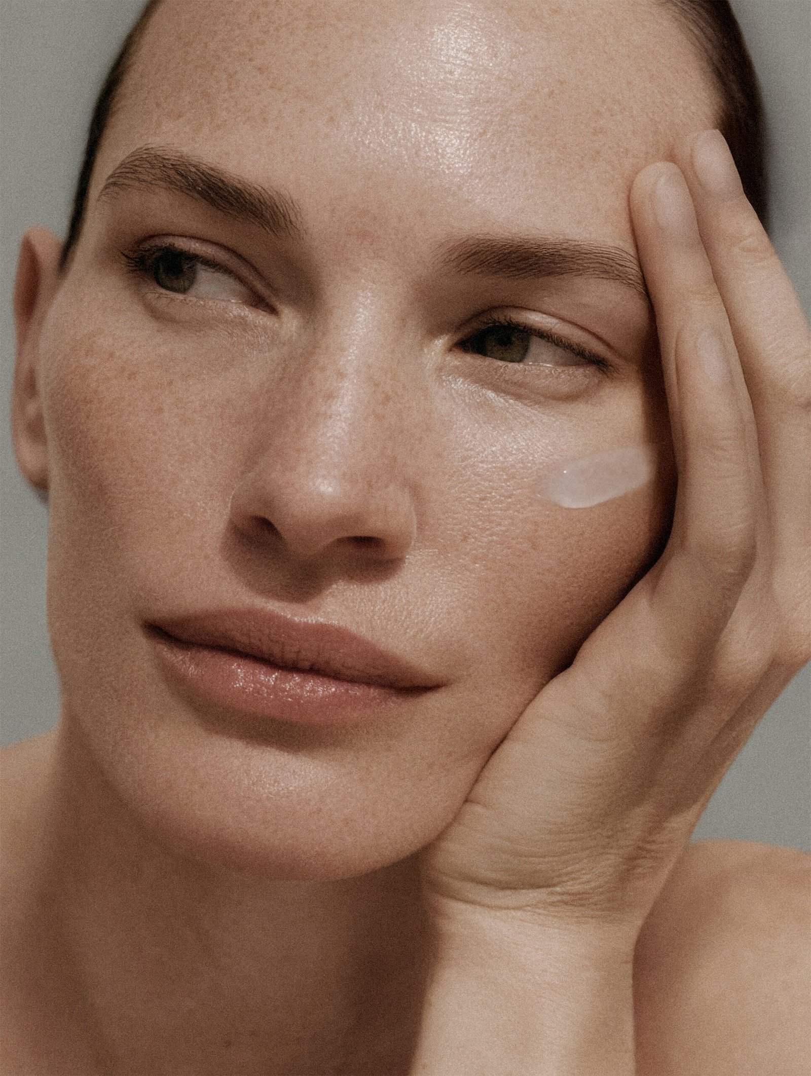 Model applying Nucleum by Naccentia – advanced luxury skincare treatment